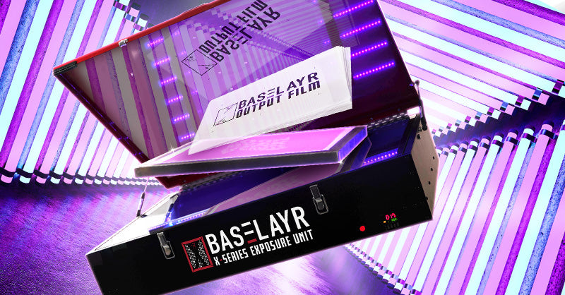 Baselayr X-Series Exposure Unit with purple and pink LED lights in a futuristic setting. The unit is open, revealing Baselayr output film and a screen. Vertical neon lights in purple and blue create a high-tech, vibrant background, highlighting the sleek design of the exposure unit.